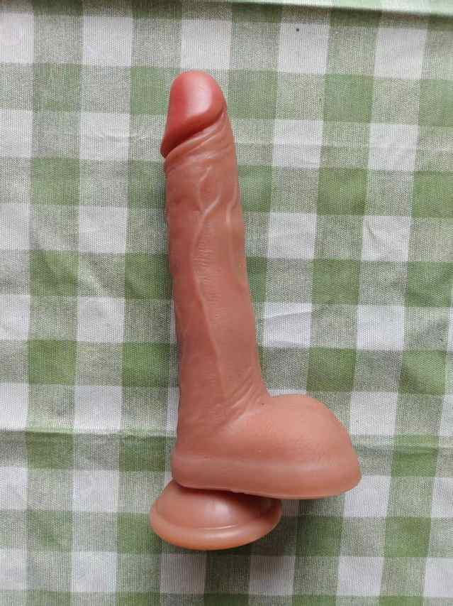 Manual phallus: Extended, flesh-brown