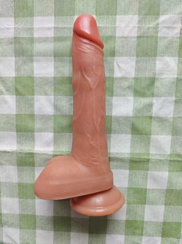 Manual phallus: Extended, flesh-brown
